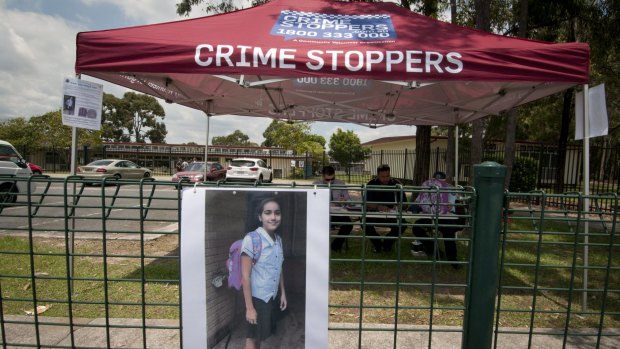Police manning a Crime Stoppers marquee in front of Marsden State High School.
