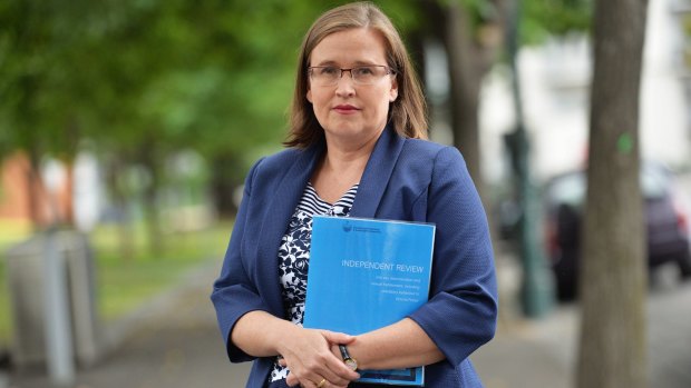 Victorian Equal Opportunity and Human Rights Commissioner Kate Jenkins in 2015 with a copy of the review of sexual harassment in the police force. 