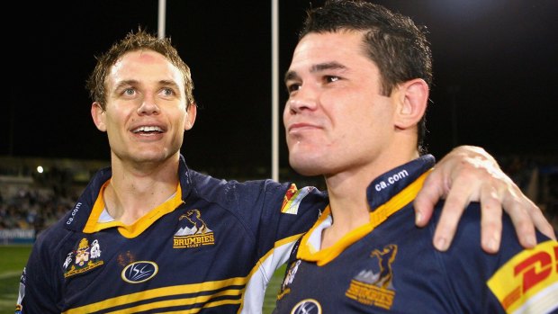 Jeremy Paul, right, with former Brumbies teammate Stephen Larkham