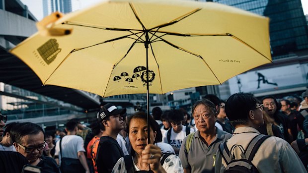 Pro-democracy protesters hold umbrellas and shout slogans during a rally outside the Hong Kong Government Complex at Admiralty district on Monday.