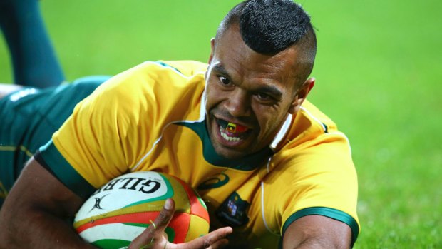 Kurtley Beale slides in for a try for Australia during a rugby test match against France in Brisbane. 