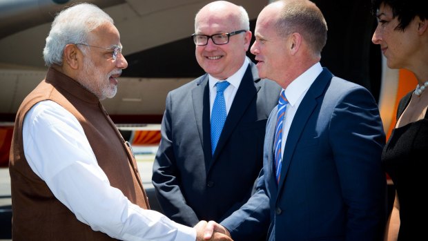 Prime Minister of India Narendra Modi, left, is welcomed by Queensland's Premier Campbell Newman, right, as Australia's Attorney-General George Brandis looks on at Brisbane Airport ahead of the G20 summit in Brisbane.