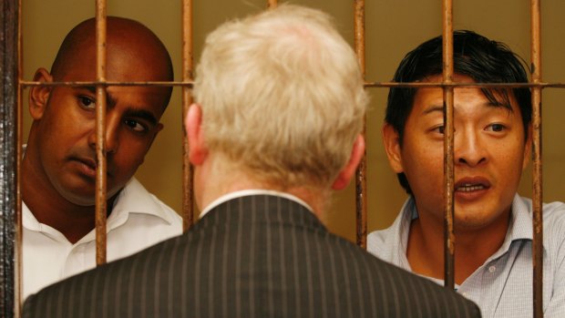 Andrew Chan (right) and Myuran Sukumaran talk with their Australian barrister, Julian McMahon, in 2010.