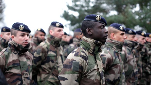 French soldiers line up to listen to a speech by the  French Defence Minister Jean Yves Le Drian, at the Satory military camp in Versailles, west of Paris, 