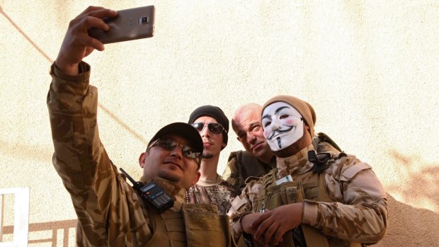 Westerners who have joined the Iraqi Christian militia Dwekh Nawsha to fight against Islamic State militants take a photograph together in Dohuk.