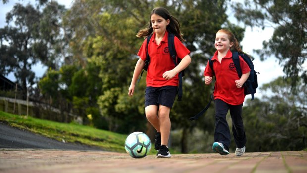 Jess with her sister,, Emma, 6, who shifts between her school uniform's trousers, shorts and dresses.