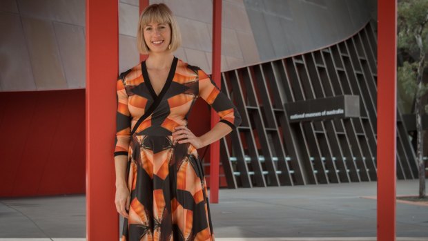 Yumi Morrissey from Zilpah Tart wearing a dress from her new collection, with a print featuring the National Museum of Australia.
