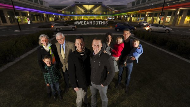 Tom Snow and husband Brooke Horne with members of the Snow family, who are supporters of gay marriage and have lit the terminal in support of the cause. 