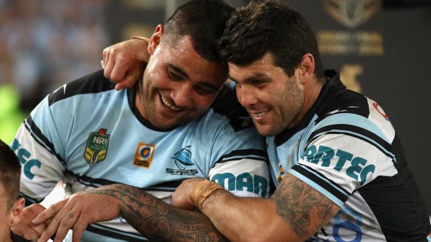Offer: Andrew Fifita celebrates premiership success with Michael Ennis.