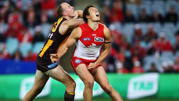 It's up there somewhere: Kurt Tippett competes for the ball against David Hale.