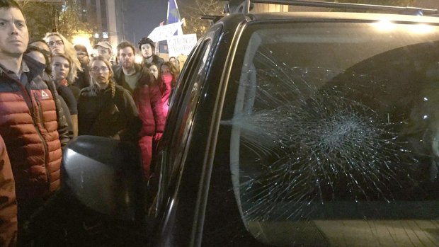 A driver's windshield was damaged after she drove in the area with protesters demonstrating against Tuesday's U.S. presidential election results.