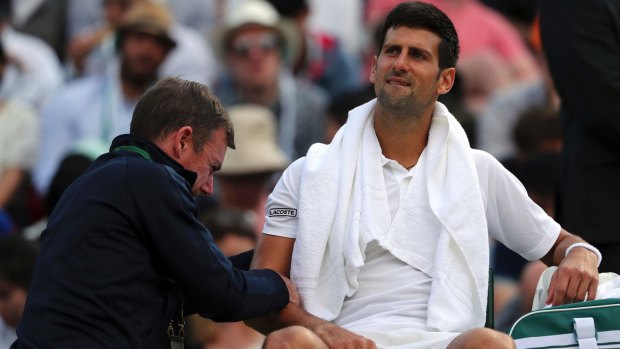 Djokovic receiving medical treatment during his match against Tomas Berdych at Wimbledon.