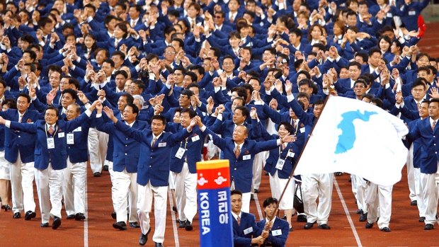 Athletes from North and South Korea march together, led by a unification flag during opening ceremonies for the 14th Asian Games in Busan, South Korea, in 2002.