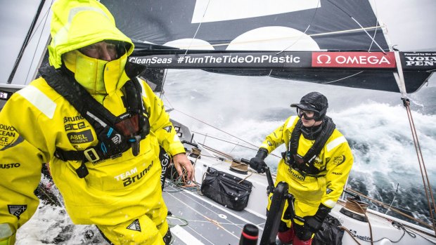 All hands on deck: Andrew Cape, left, comes on deck to help teammate Kyle Langford on the racing yacht Brunel. 
