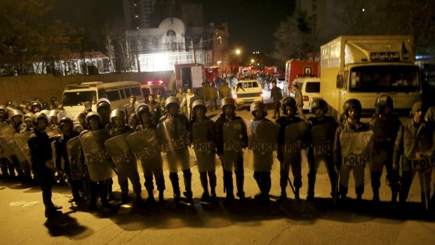 Security guards line up in front of the embassy.