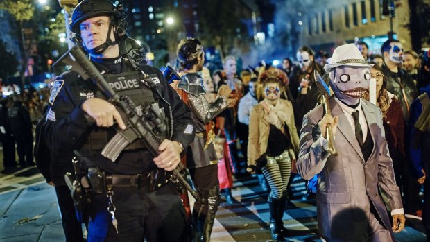 Heavily armed police guard as revelers marched in the Greenwich Village Halloween parade just hours after the attack.
