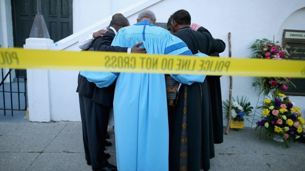 Reverend Sidney Davis and other  pastors pray together outside the historic Emanuel African Methodist Episcopal Church on Thursday. 