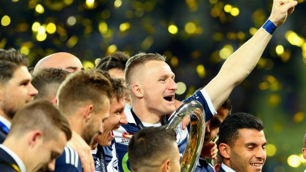 Victory players hold the trophy aloft after defeating Sydney FC in the A-League grand final on Sunday.