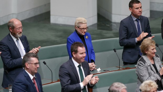 Former speaker Bronwyn Bishop holds her hands as other MPs applaud the election of Tony Smith as her replacement on Monday.