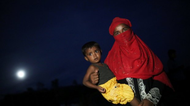 A Rohingya woman holds a child at Palangkhali refugee camp in Cox's Bazaar, Bangladesh on Wendnesday.