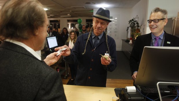 Veteran weed campaigner Steve DeAngelo, chief executive of Harborside dispensary, makes the first sale of recreational marijuana to attorney Henry Wykowski on January 1.