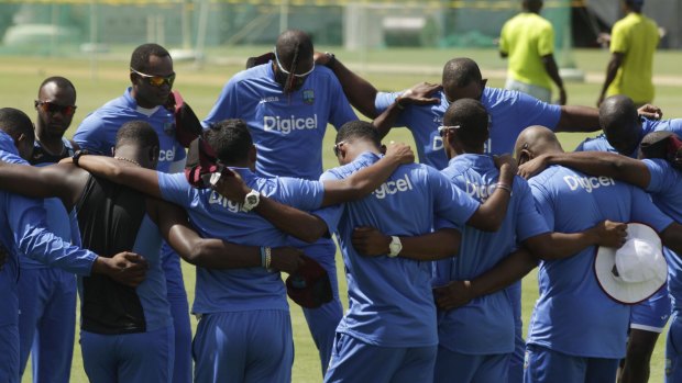 West Indies' players pray before a practice session in Roseau, Dominica, on Monday.
