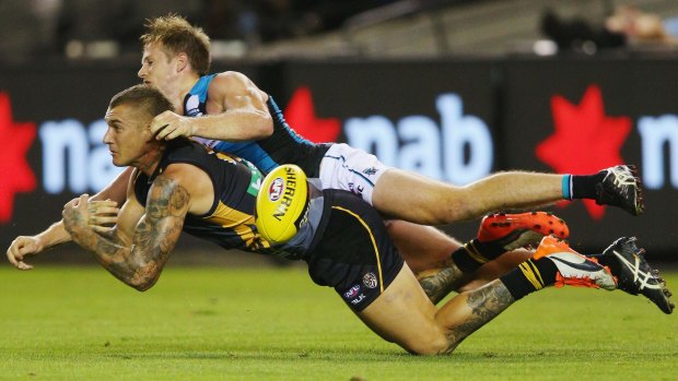 No ball:  Dustin Martin loses control after a tackle by Port's Tom Jonas.