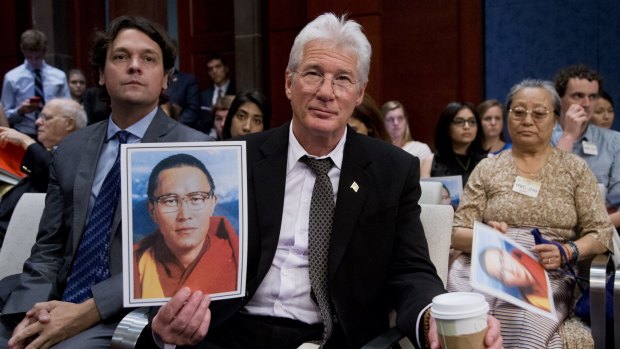 American actor and activist Richard Gere holds a photo of Tulku Tenzin Delek Rinpoche, one of the most respected and revered Tibetan lamas, who died in custody in a Chinese prison on July 12.