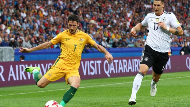 Mathew Leckie clears the ball while under pressure from Niklas Suele of Germany.
