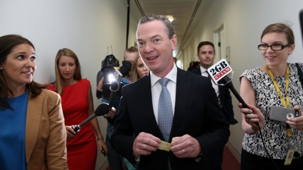 Education Minister Christopher Pyne surrounded by media after defending Prime Minister Tony Abbott on Tuesday.