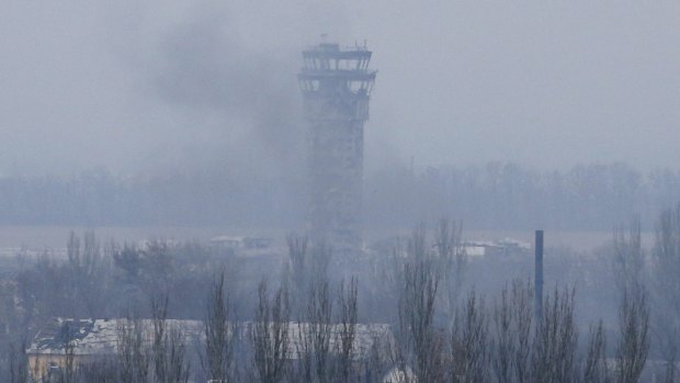 Ongoing fighting: Smoke rises near the traffic control tower of Donetsk airport last week.