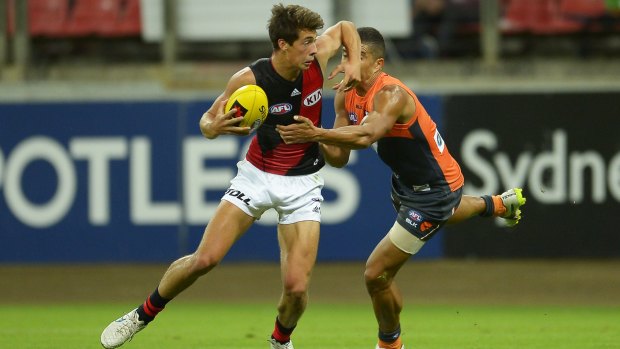 Caught: Essendon's Kyle Langford is tackled in Friday night's clash with the Giants. 
