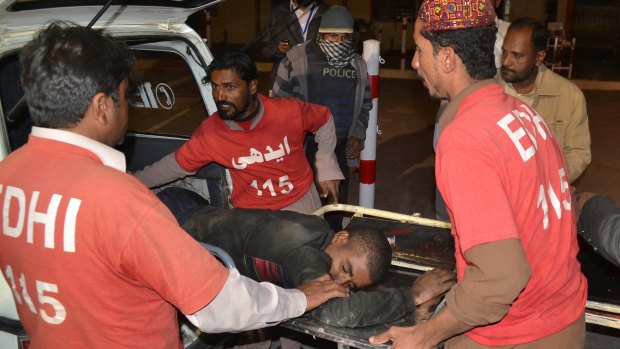 Pakistani volunteer medics rush an injured person to a hospital in Quetta after the police academy attack. 