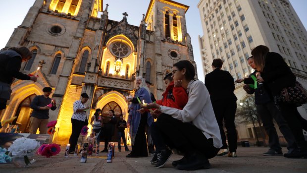 Undocumented immigrants Ana Ortiz and her nephew, Rene, join community activists as they gather in front of San Fernando Cathedral for a vigil on the eve of Donald Trump's inauguration in San Antonio, Texas.