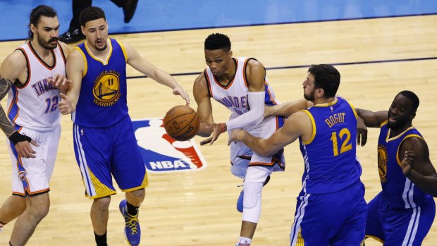 No way through: Oklahoma City Thunder guard Russell Westbrook tries to get past Golden State Warriors defenders Klay Thompson, Andrew Bogut and Draymond Green.