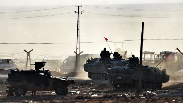 Armoured vehicles of the Turkish army patrol along the Turkish-Syrian border.