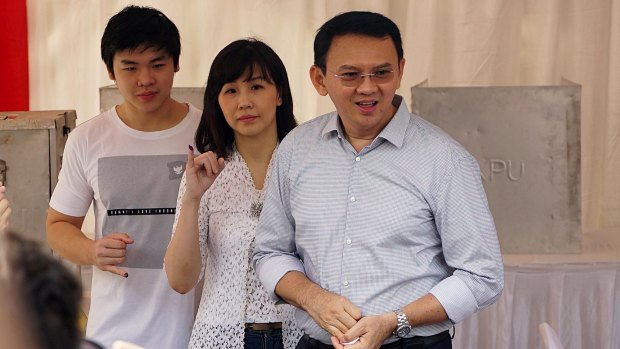 Jakarta Governor Basuki Tjahaja Purnama, known as Ahok, right,  with his wife Veronica and son Nicholas at a polling station in Jakarta.