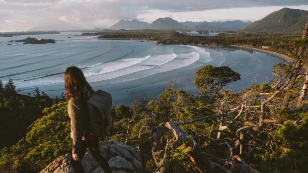 A hiker at Cox Bay overlooking Tofino and the Pacific Rim National Park.