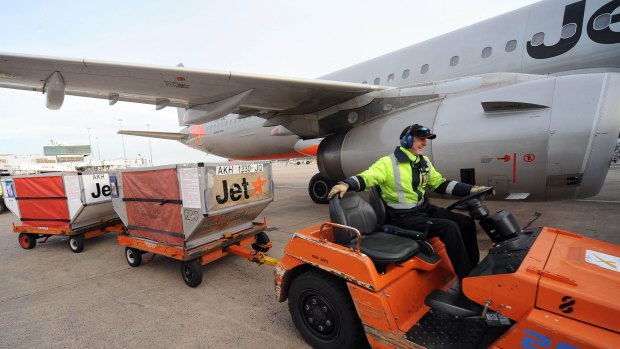 A baggage handler delivers luggage  at Melbourne Airport.