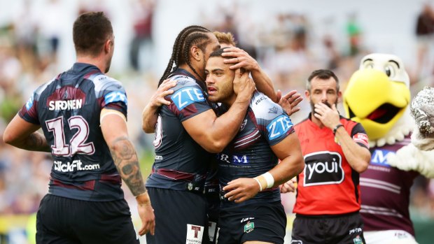 Try time: Dylan Walker celebrates scoring during Manly's big win.