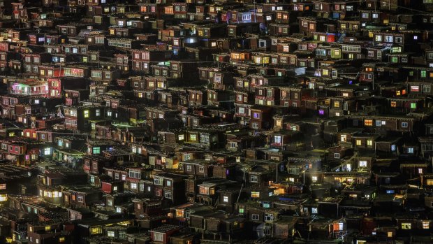 The surreal Larung Gar encampment at night. The coloured glass or plastic windows of the huts make for an impressive sight as night falls.