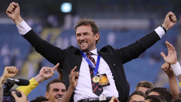 Leader of champions: Tony Popovic receives the hero treatment from his players after winning the ACL.