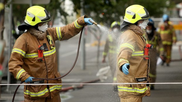 Firefighters are hosed down after fighting the blaze.