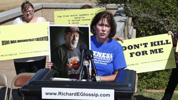 Nancy Vollertsen holds a photo of her brother, Greg Wilhoit, who spent five years on Oklahoma's death row before being exonerated, during a rally to stop the execution of Richard Glossip in Oklahoma City on Tuesday. 