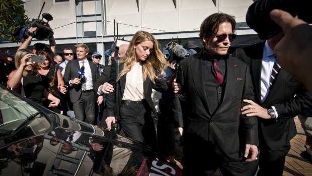 Actor Johnny Depp leaves court with his wife Amber Heard.