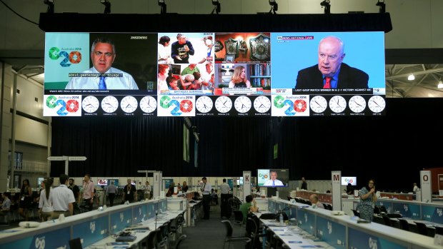 Treasurer Joe Hockey appears on the big screen at the G20 media centre.