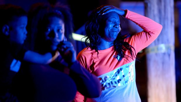 A woman reacts at the scene of the deadly shooting in Wilkinsburg.