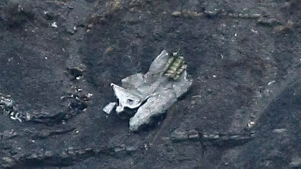Debris of the crashed Germanwings passenger jet is scattered on the mountain side.