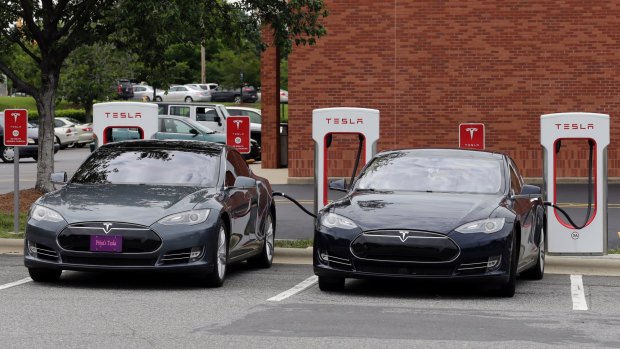 Full charge ahead: Tesla cars power up at a charging station. 