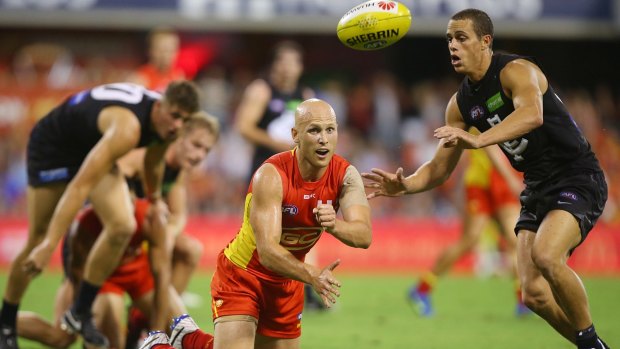 A touch of class: Gary Ablett of the Suns goes to ground but gets a handball away.